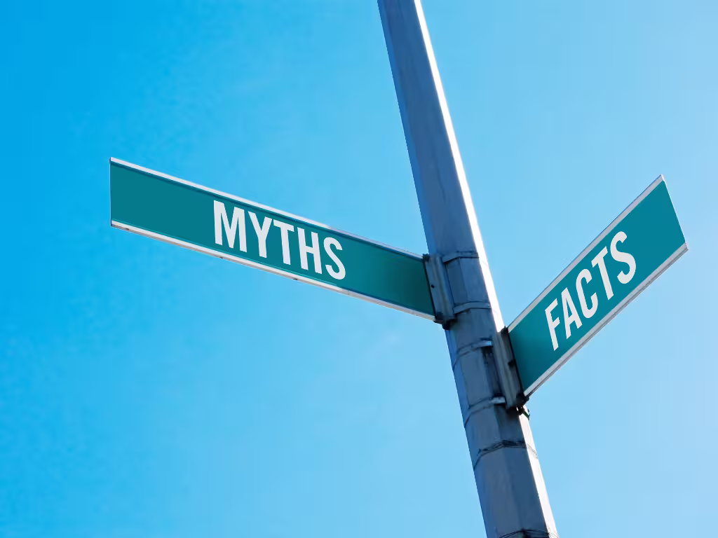 A street sign showing two streets labelled "Facts" and "Myths"